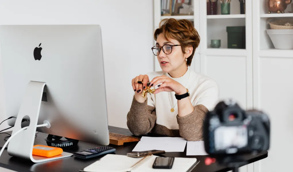 Female OLA teaching online at desk